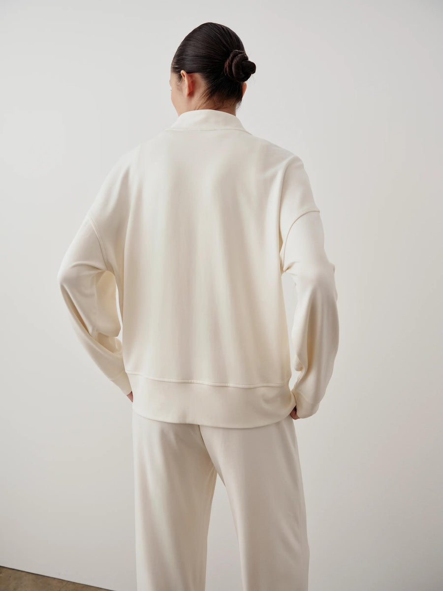 Cream-colored Modal Popper Jacket, collarless with relaxed fit; showcased with matching trousers.