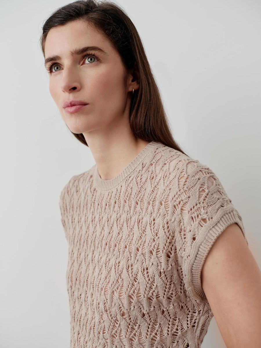 Emello Open Knit Short Sleeve Top in Neutral Beige, crafted from Italian-spun cotton with an intricate open-stitch design.
