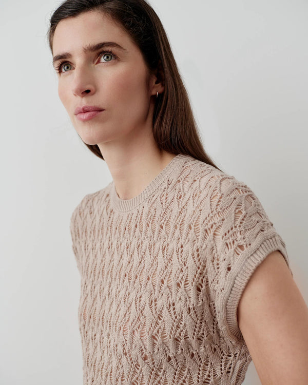 Emello Open Knit Short Sleeve Top in neutral beige, showcasing intricate open-stitch pattern and soft elegance.