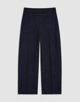 Back view of Emello Pleated Wool Trousers in navy, illustrating the expert tailoring and soft drape of the fabric.