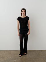 Emello Plissé Boat Neck Top in black, featuring a wide boat neckline and fluid drape.