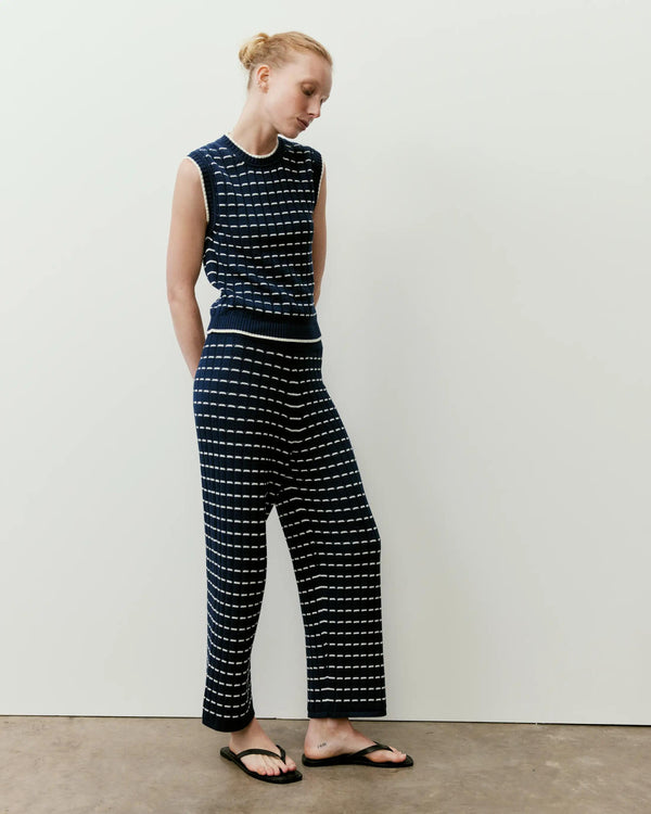 Emello Pointelle Knit Cropped Trousers in navy, featuring a refined grid stitch and ribbed waistband.