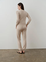 Model wearing Emello's neutral silk blend pointelle trousers, showcasing the vertical detailing and fluid drape.