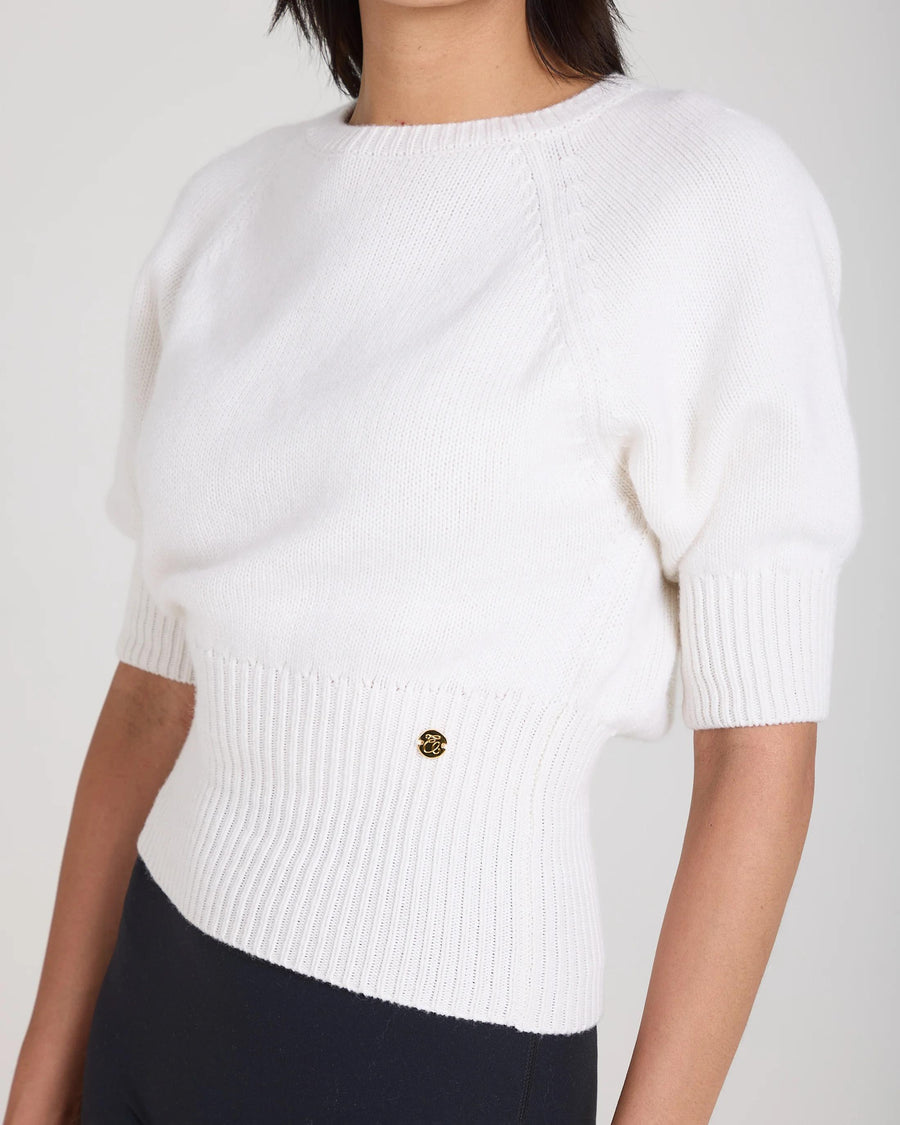 Cream puff sleeve sweater in merino wool and cashmere blend, with gold hardware detail and deep ribbed waist.