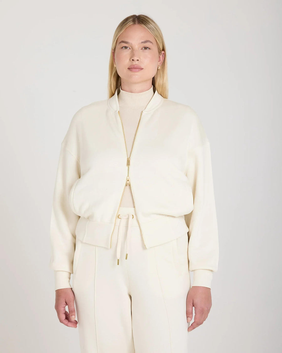Cream zip-through jacket in buttery-soft lyocell with gold hardware, showcasing a relaxed fit.