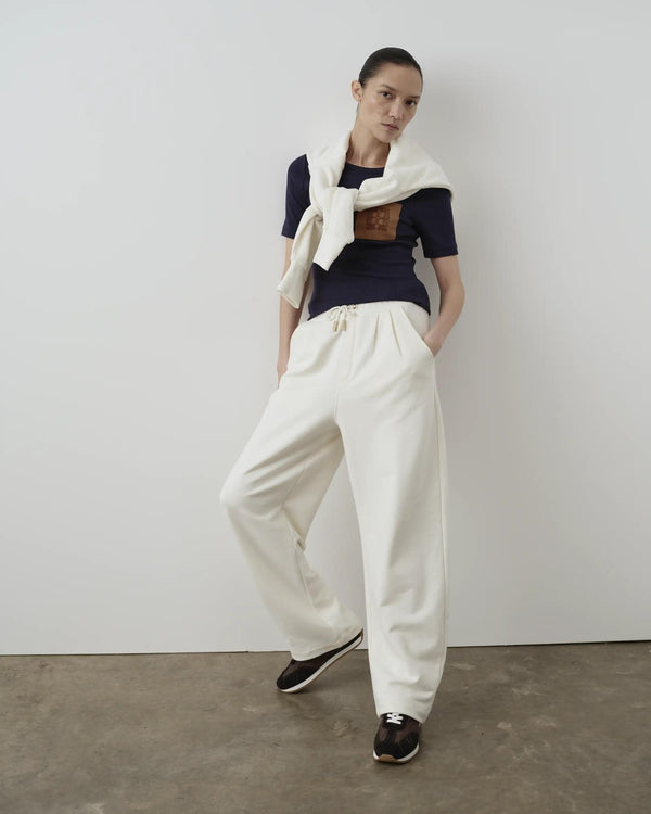 Model wearing Emello Relaxed Straight Leg Trousers in cream against a neutral background.