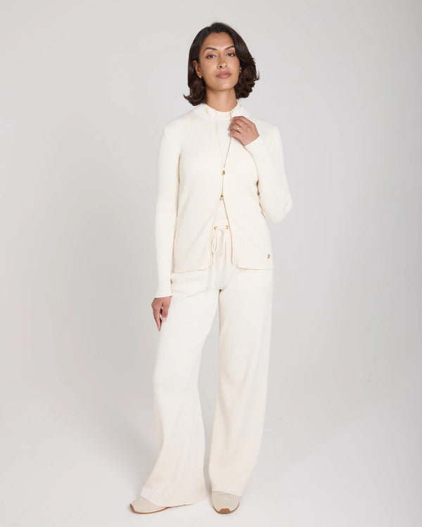 Sorella Ribbed Zip Through Cardigan in Cannoli Cream with a tactile ribbed texture, worn by a model with a composed posture.
