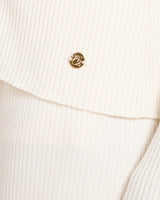 Close-up of the Sorella Ribbed Zip Through Cardigan in Cannoli Cream showing gold-finish embellishments and ribbed texture.