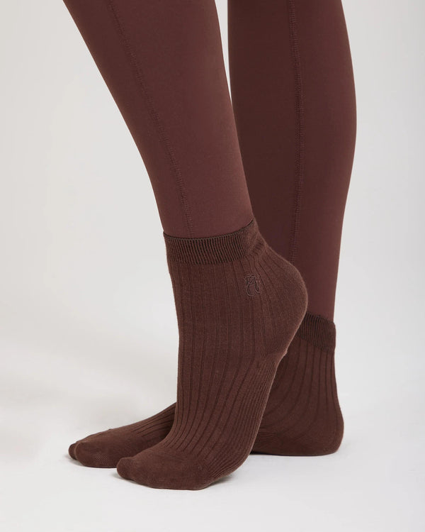 Chocolate brown ribbed cotton half-crew socks with subtle embroidery, paired with matching leggings.