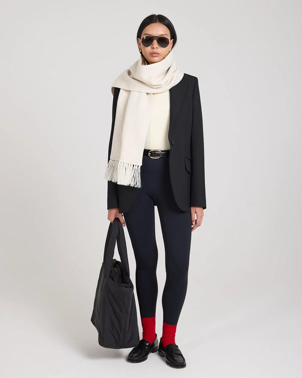 A model wearing Emello's ribbed cotton half-crew socks in red with embroidered detail, styled with versatile elegance.