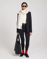 A model wearing Emello's ribbed cotton half-crew socks in red with embroidered detail, styled with versatile elegance.