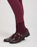 Burgundy half-crew socks with ribbed texture and subtle embroidery, styled with burgundy leggings and loafers.