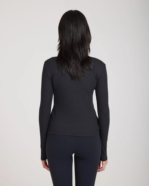 Back view of Emello Forma Ribbed Lyocell-Cotton Blend Turtleneck Top in black, showcasing slim fit and ribbed texture.