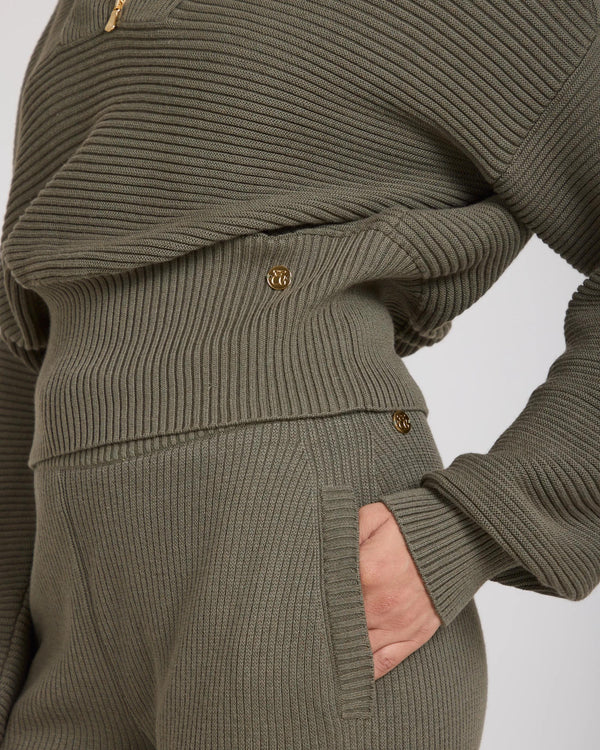 Olive ribbed half zip jumper with gold accents crafted in Italy, showcasing a refined and relaxed style.
