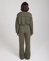 Back view of model wearing Emello Sorella Ribbed Half Zip Jumper in Olive.