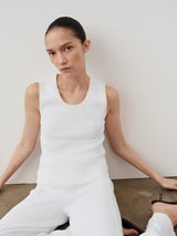 Emello Tonal Ribbed Knit Tank Top worn by model seated softly against a cream wall.