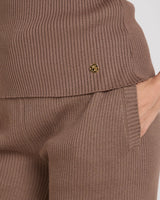 Close-up of Emello's Sorella Ribbed Knit Vest in Taupe, showcasing ribbed texture and gold-finish metal tab