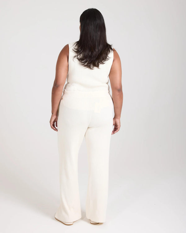 Back view of Sorella Ribbed Knit Wide Leg Trousers in cream, featuring soft ribbed texture and gold disc embellishments.