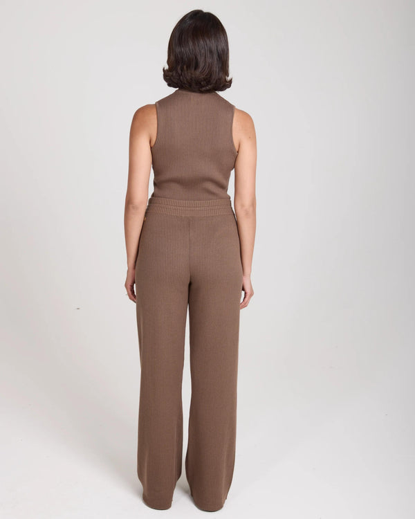 Back view of a woman wearing Emello Sorella Ribbed Knit Wide Leg Trousers in Taupe.
