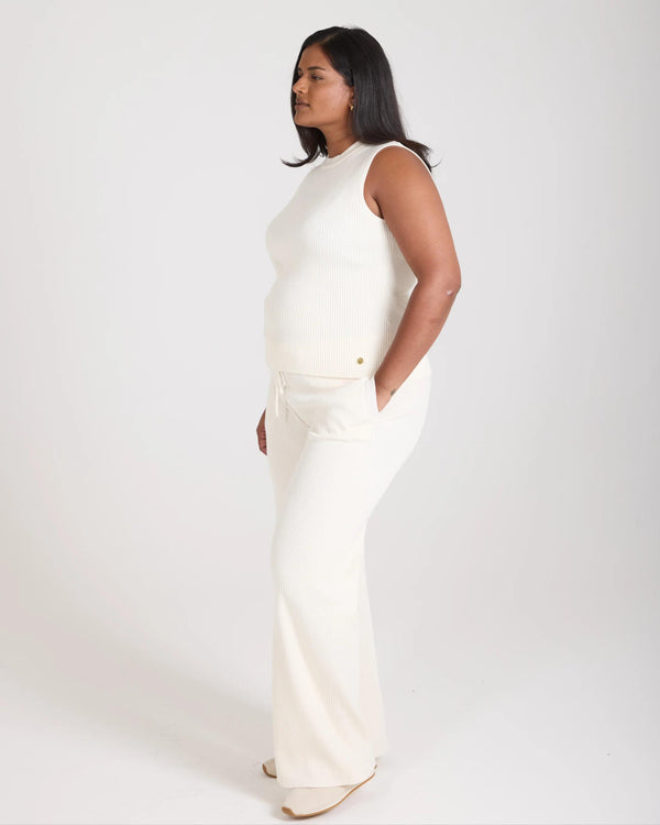 Sorella Ribbed Knit Vest in Cream with Gold-finish Embellishments, worn by a model showcasing its slim fit and sleeveless design.