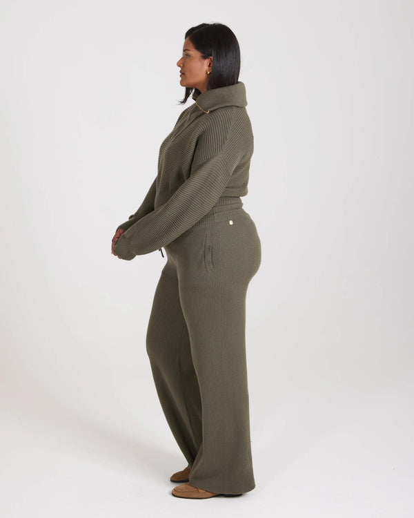 Side profile view of the Sorella Ribbed Knit Wide Leg Trousers in olive, showcasing relaxed fit and tactile ribbed texture.