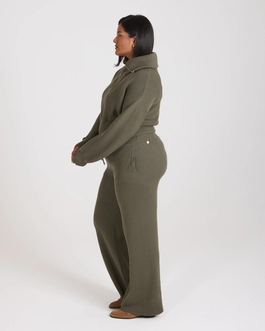 Side profile view of the Sorella Ribbed Knit Wide Leg Trousers in olive, showcasing relaxed fit and tactile ribbed texture.