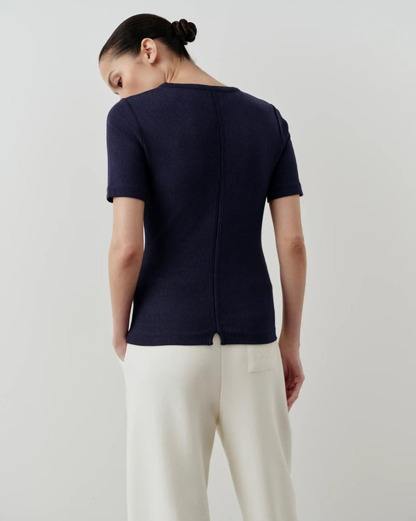Navy ribbed tee with a fitted silhouette and short sleeves, viewed from the back.