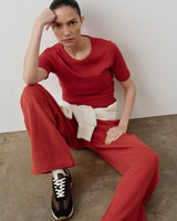 Emello Ribbed Pocket Tee in red, showcasing a refined, body-skimming silhouette, styled with tonal embroidery and breathable stretch fabric.
