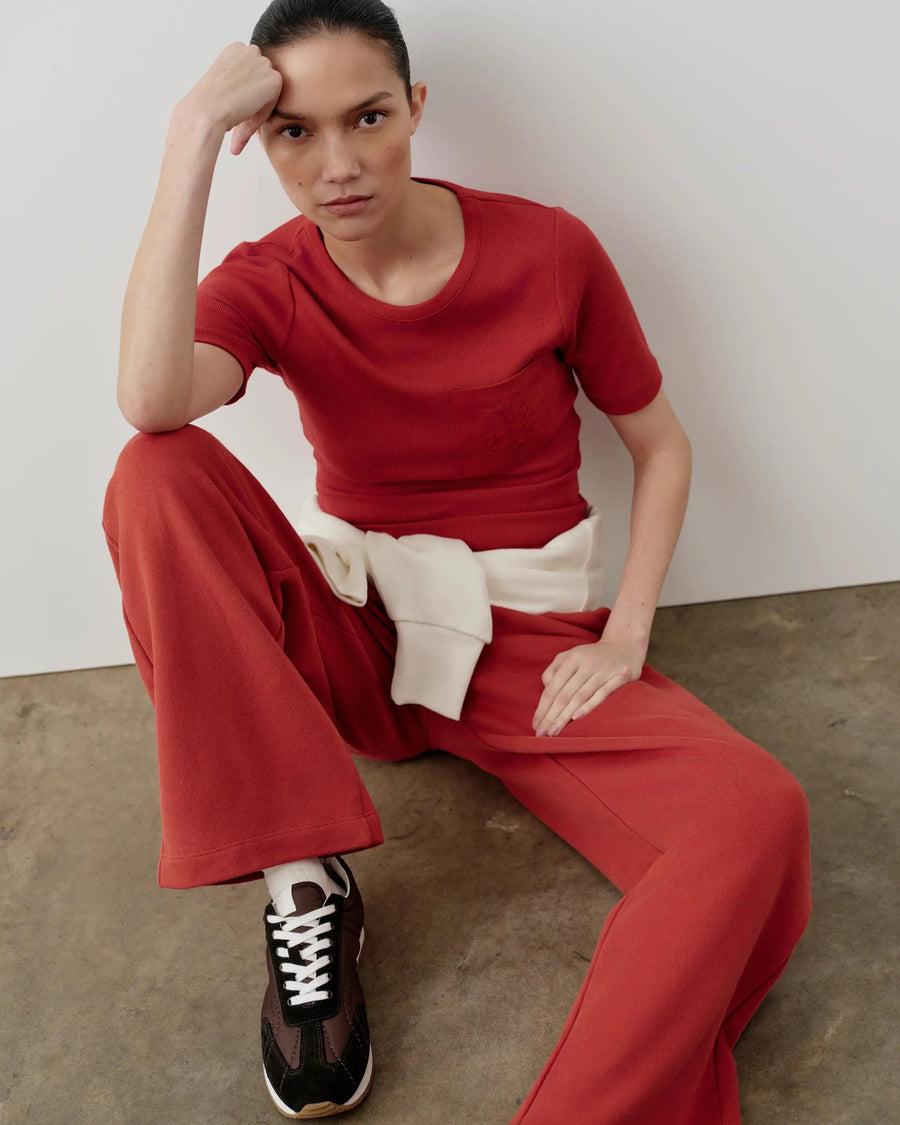 Emello Ribbed Pocket Tee in red, showcasing a refined, body-skimming silhouette, styled with tonal embroidery and breathable stretch fabric.