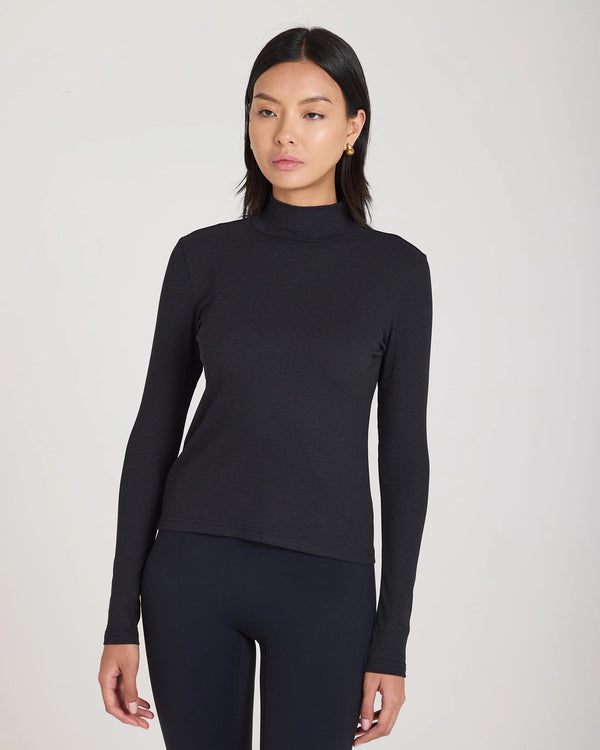 Emello Forma Ribbed Lyocell-Cotton Blend Turtleneck Top in black.