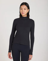 Emello Forma Ribbed Lyocell-Cotton Blend Turtleneck Top in black.