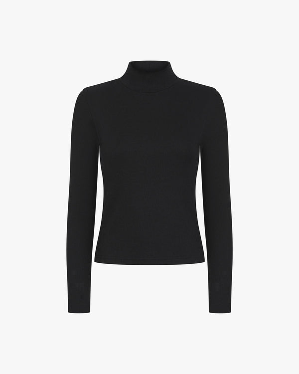 Black ribbed turtleneck top made from lyocell-cotton with an embroidered badge.