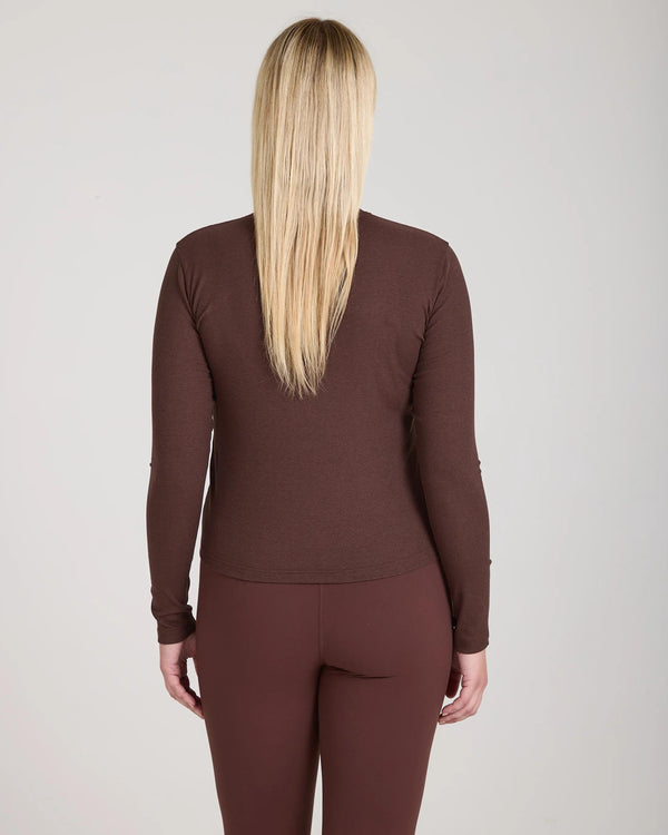 Back view of Forma Ribbed Lyocell-Cotton Blend Turtleneck Top in Chocolate, showcasing its sculpted fit and rich texture.