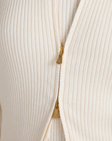 Close-up of Sorella Ribbed Zip Through Cardigan in cream with gold zip detailing.