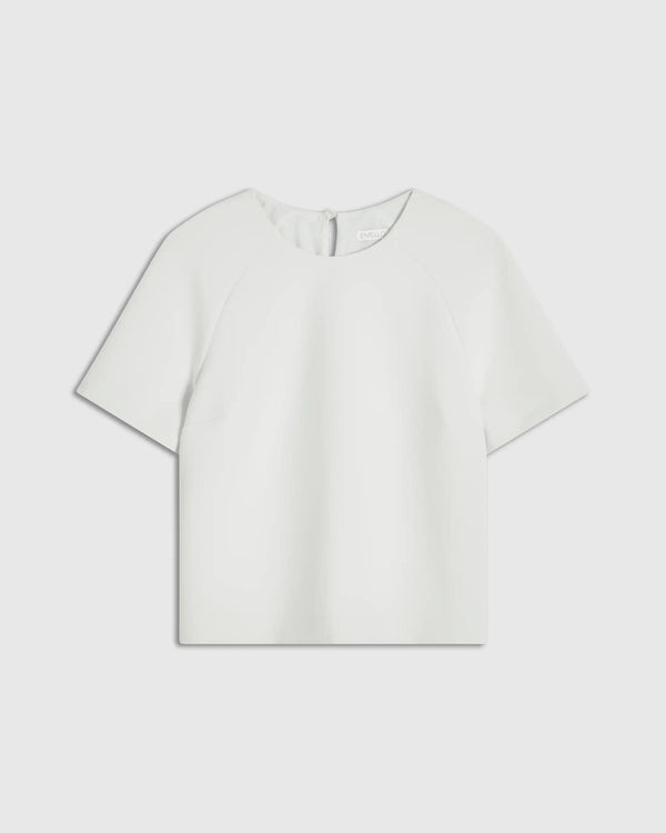 Mist green structured short sleeve top with sculptural silhouette by Emello, featuring seamless edges and raglan sleeves.