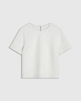 Mist green structured short sleeve top with sculptural silhouette by Emello, featuring seamless edges and raglan sleeves.