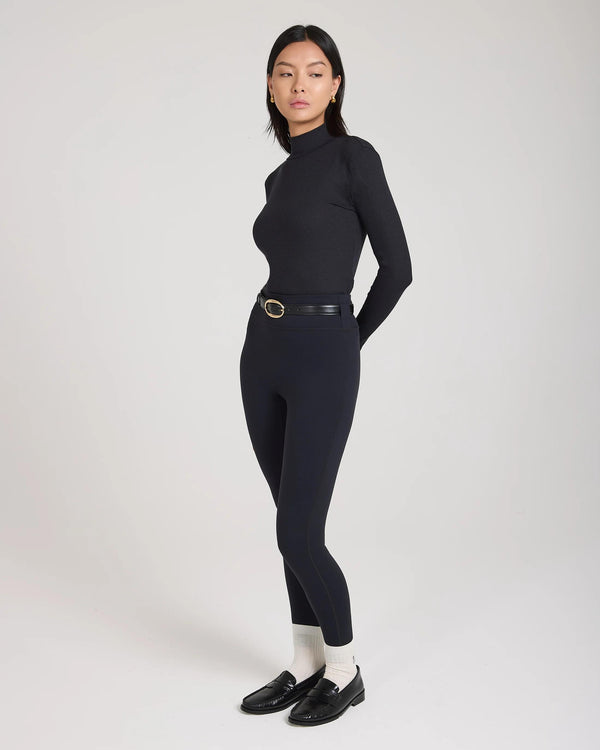 Model wearing Emello Forma Super Soft Sculpting Leggings in Black with belt loops, demonstrating a refined and poised silhouette.