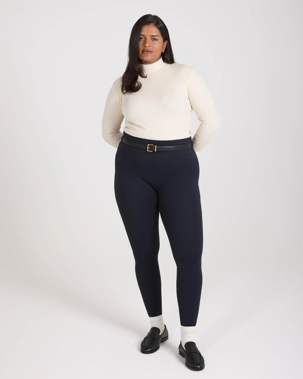 Black super soft sculpting leggings with belt loops, worn with cream turtleneck.