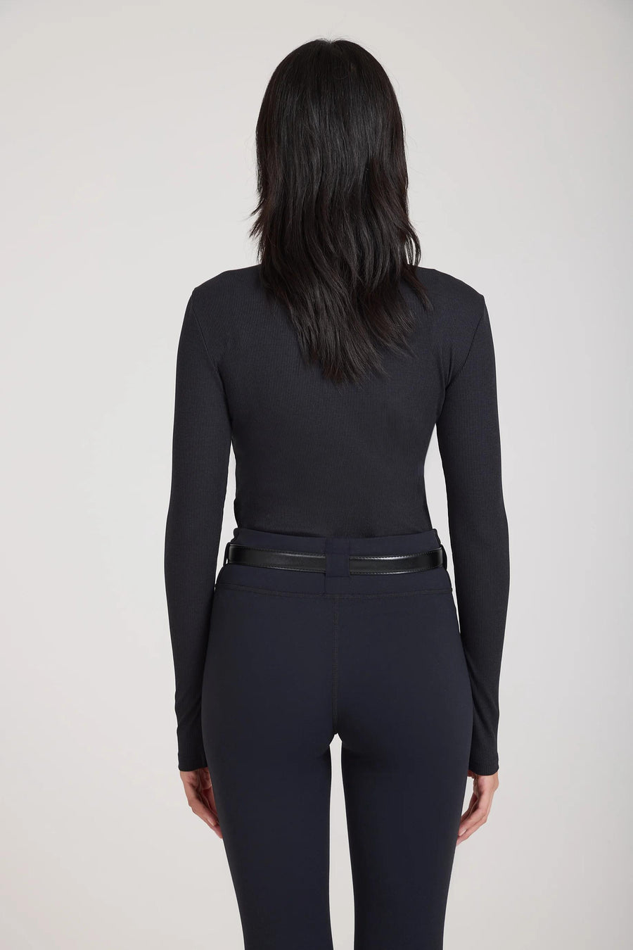 Emello Forma Super Soft Sculpting Leggings with Belt Loops in Black, showcasing the back view with a clean-finished hem and embroidered logo badge.