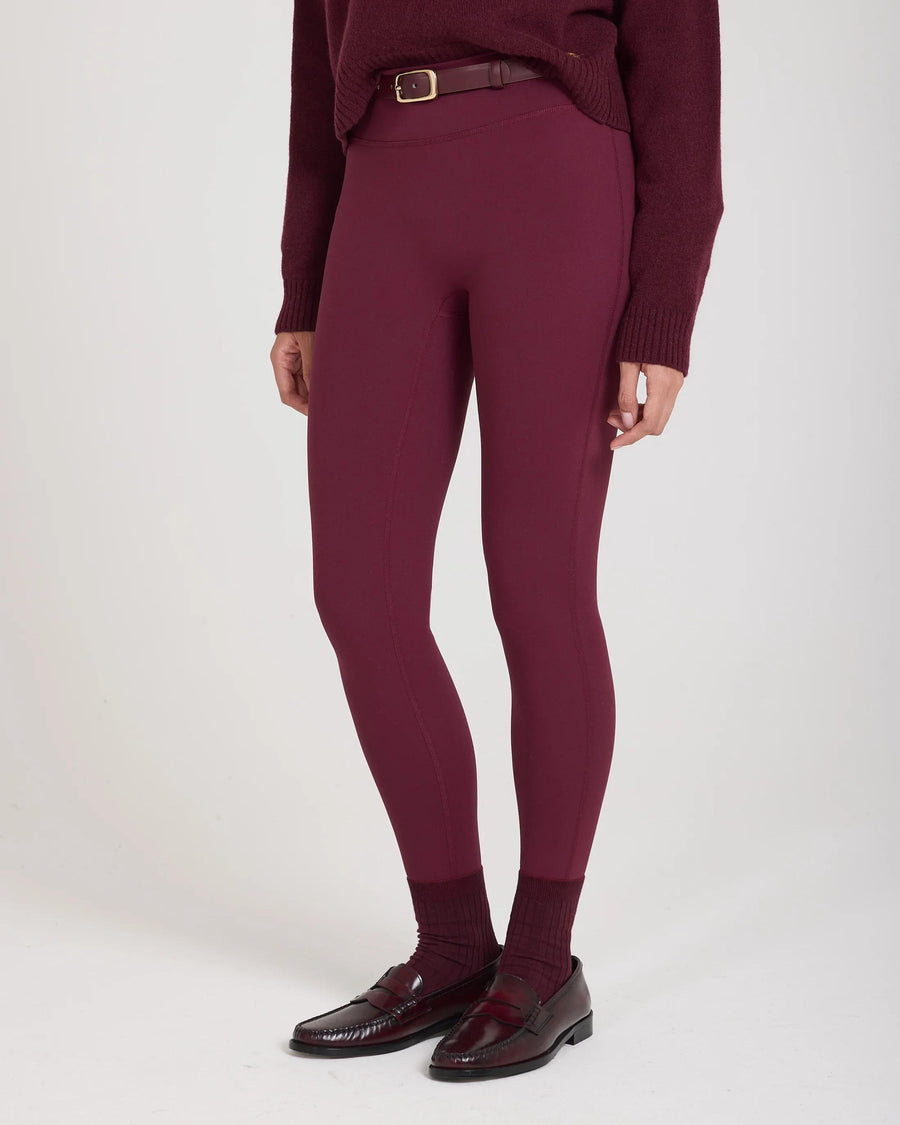 Sculpting purple leggings with belt loops, featuring a buttery soft texture and form-fitting design.