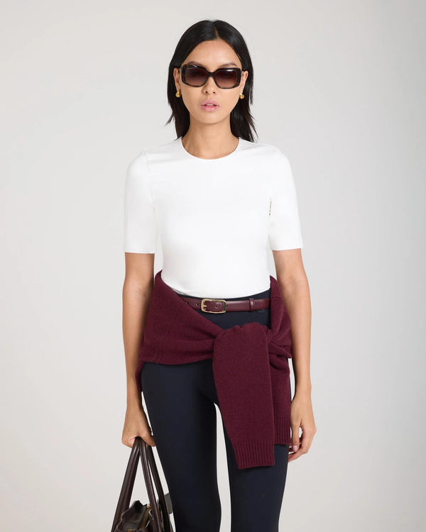 Emello Forma Silky Lyocell Jersey Double-Layer Top in cream, featuring a crew neckline and slim fit, worn by a model with a burgundy sweater tied around the waist and black pants.