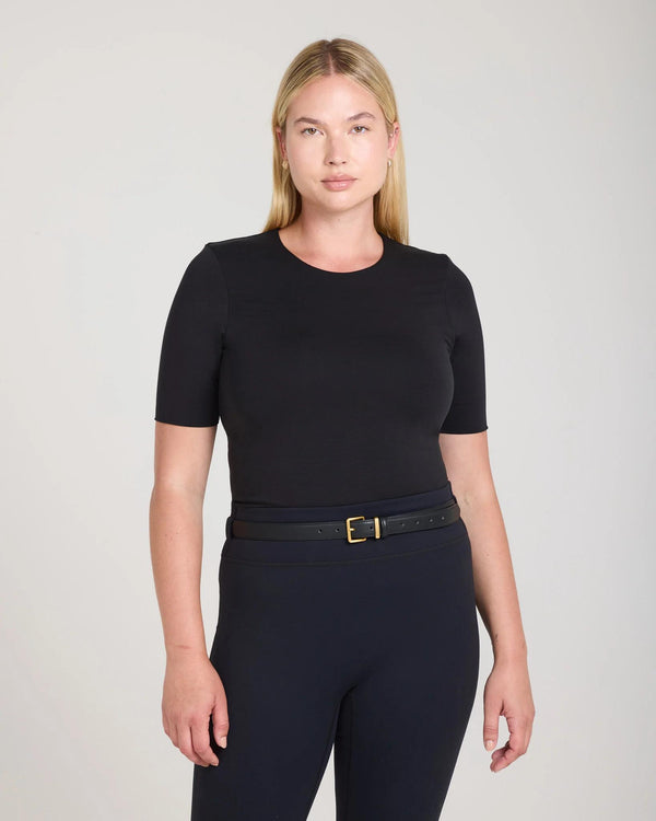Model wearing the Emello Forma Silky Lyocell Jersey Double-Layer Top in Black, showcasing a slim fit with a crew neck.