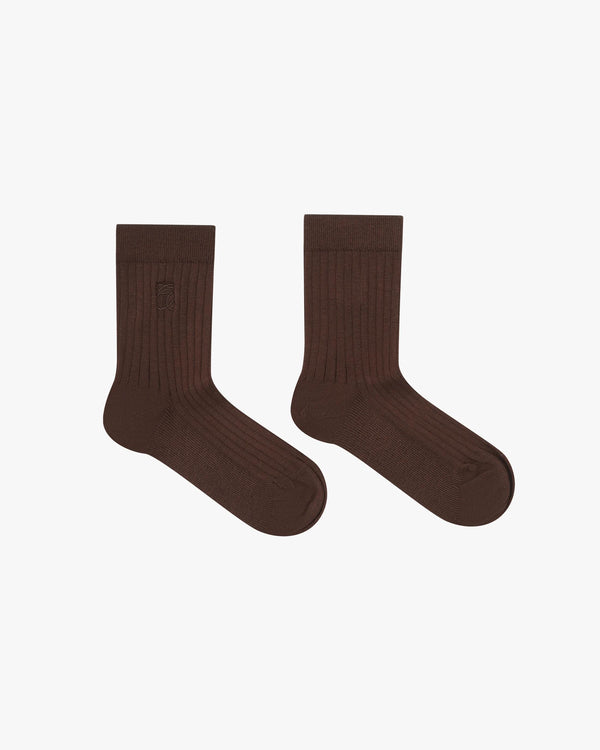 Chocolate brown ribbed cotton socks by Emello, featuring a half-crew silhouette and embroidered logo.