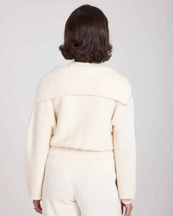 Back view of the Sorella Ribbed Half Zip Jumper in Cream, showcasing ribbed texture and relaxed fit.