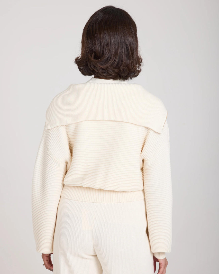Back view of the Sorella Ribbed Half Zip Jumper in Cream, showcasing ribbed texture and relaxed fit.
