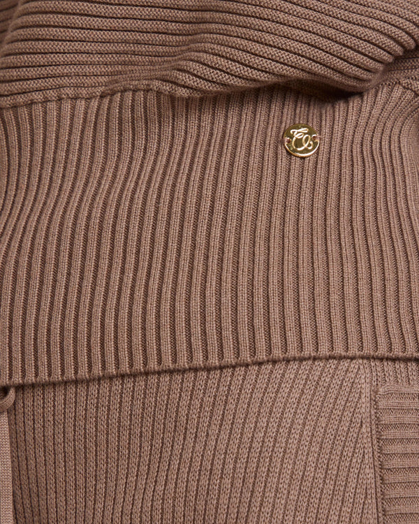 Close-up of the Sorella Ribbed Half Zip Jumper in luxurious taupe cotton-cashmere, showcasing gold branded disc.