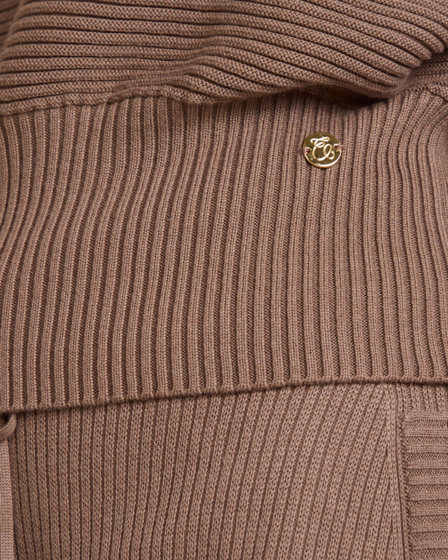 Close-up of the Sorella Ribbed Half Zip Jumper in luxurious taupe cotton-cashmere, showcasing gold branded disc.