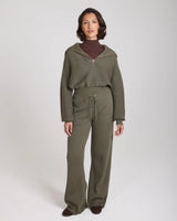 Model wearing Emello Sorella Ribbed Knit Wide Leg Trousers in Olive.