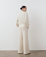 Model wearing Emello's Striped Knit Jacket in a relaxed, boxy silhouette with blouson sleeves.