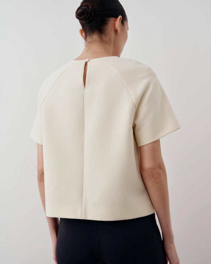 Emello Structured Short Sleeve Top in Cream, featuring a back keyhole and sculptural silhouette.
